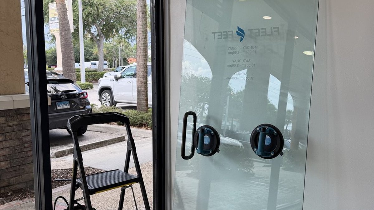Commercial storefront entry door with a surface-mounted closer
