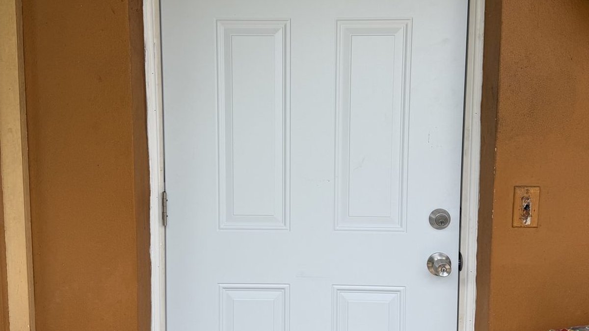 Front entry door being repaired at a South Florida home